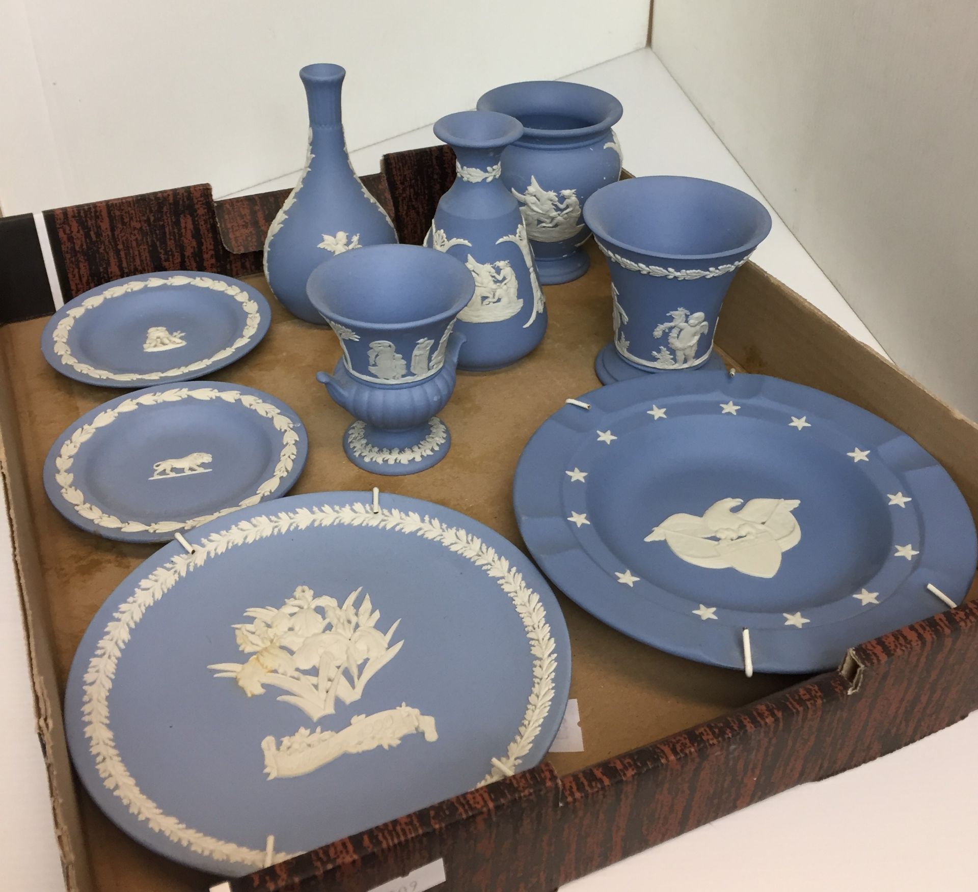 Nine pieces Wedgwood blue Jasper ware including Lion plate 11cm diameter,
