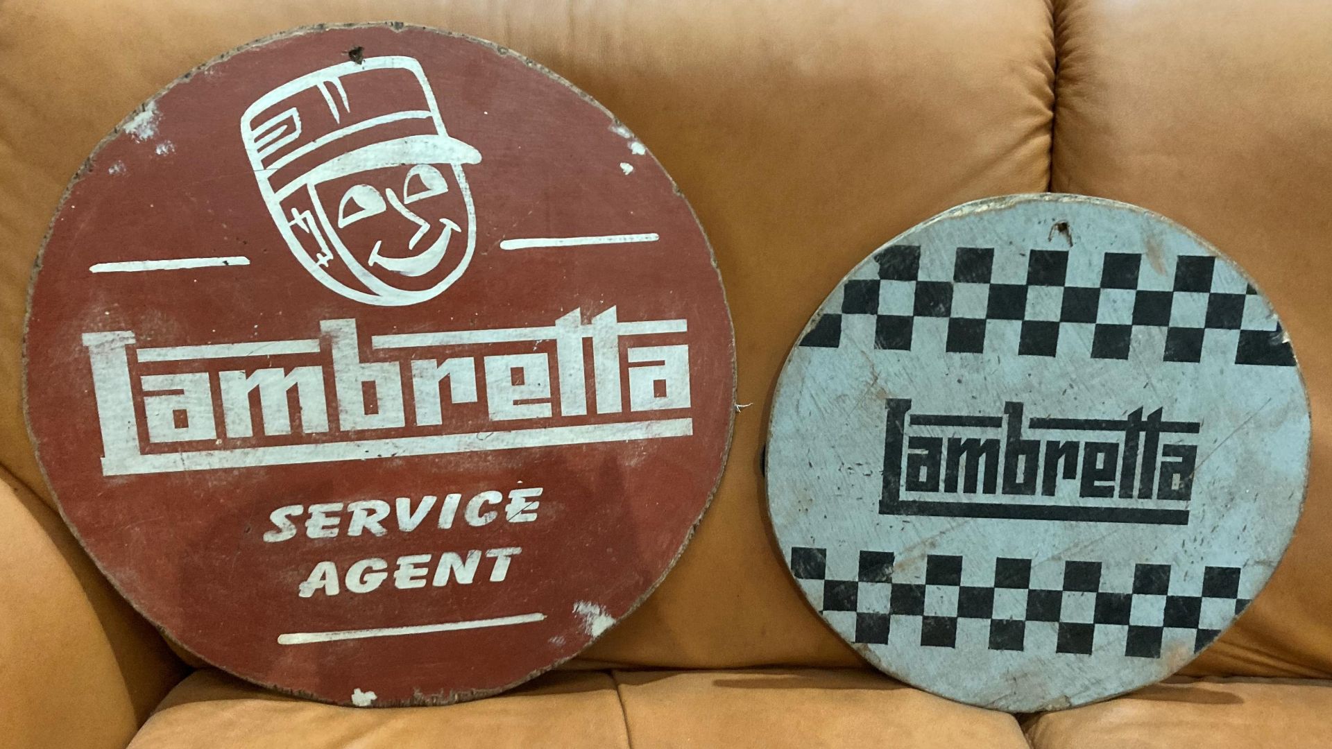 Two reproduction painted circular signs on plywood 'Lambretta' 38cm and 48cm in diameter.