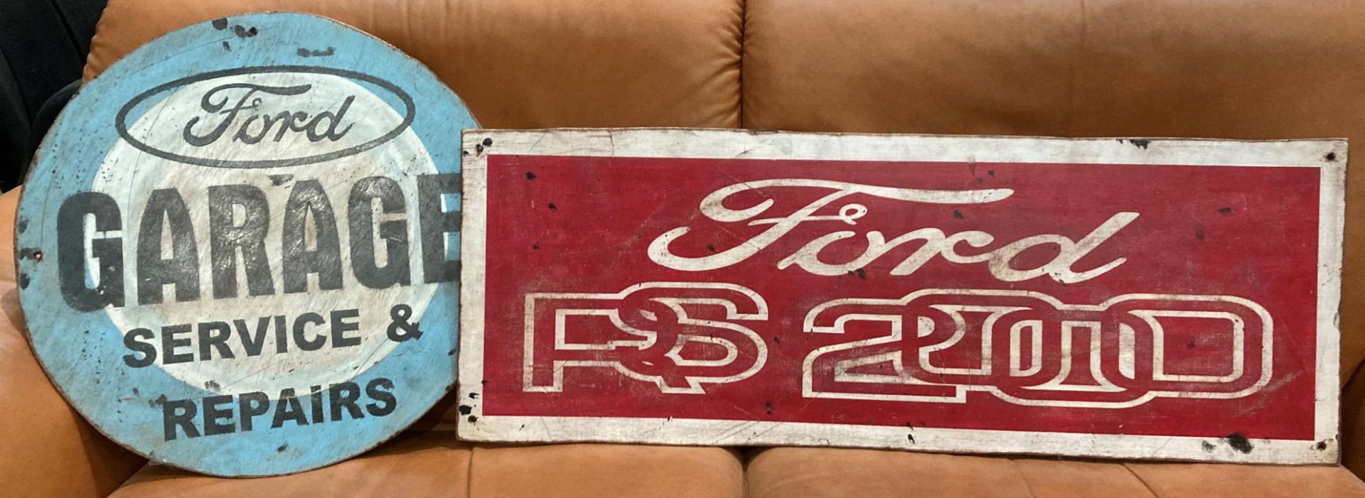 Two reproduction painted signs on plywood - one circular 'Ford Garage' 50cm diameter and one