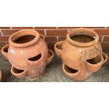 A pair of terracotta strawberry pots, each 42cm high - one with chip to base.