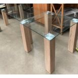 Two glass coffee tables on wood legs,