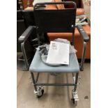 An Invacare Cascata H7207 mobile toilet chair (unused) complete with footrests and manual.