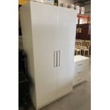 A white laminate wardrobe with two white gloss doors 100cm x 200cm high and a matching chest of