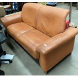 An Ekornes Stressless leather large 2 seater settee in a mustard colour with light oak feet.