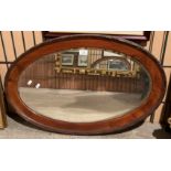 A walnut framed oval wall mirror,