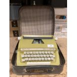 A Petite Feather Touch portable typewriter in case