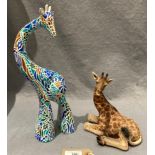 A Vivid Arts resin giraffe figurine laid down,18cm high,