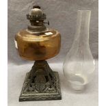 A brown glass and metal oil lamp with glass funnel,