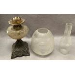 A glass and metal oil lamp with etched glass shade (cracked) and glass funnel,