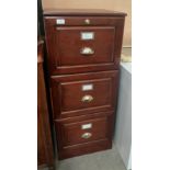 An oak three drawer filing cabinet,