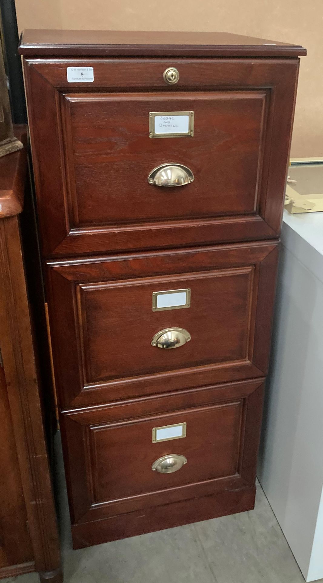 An oak three drawer filing cabinet,