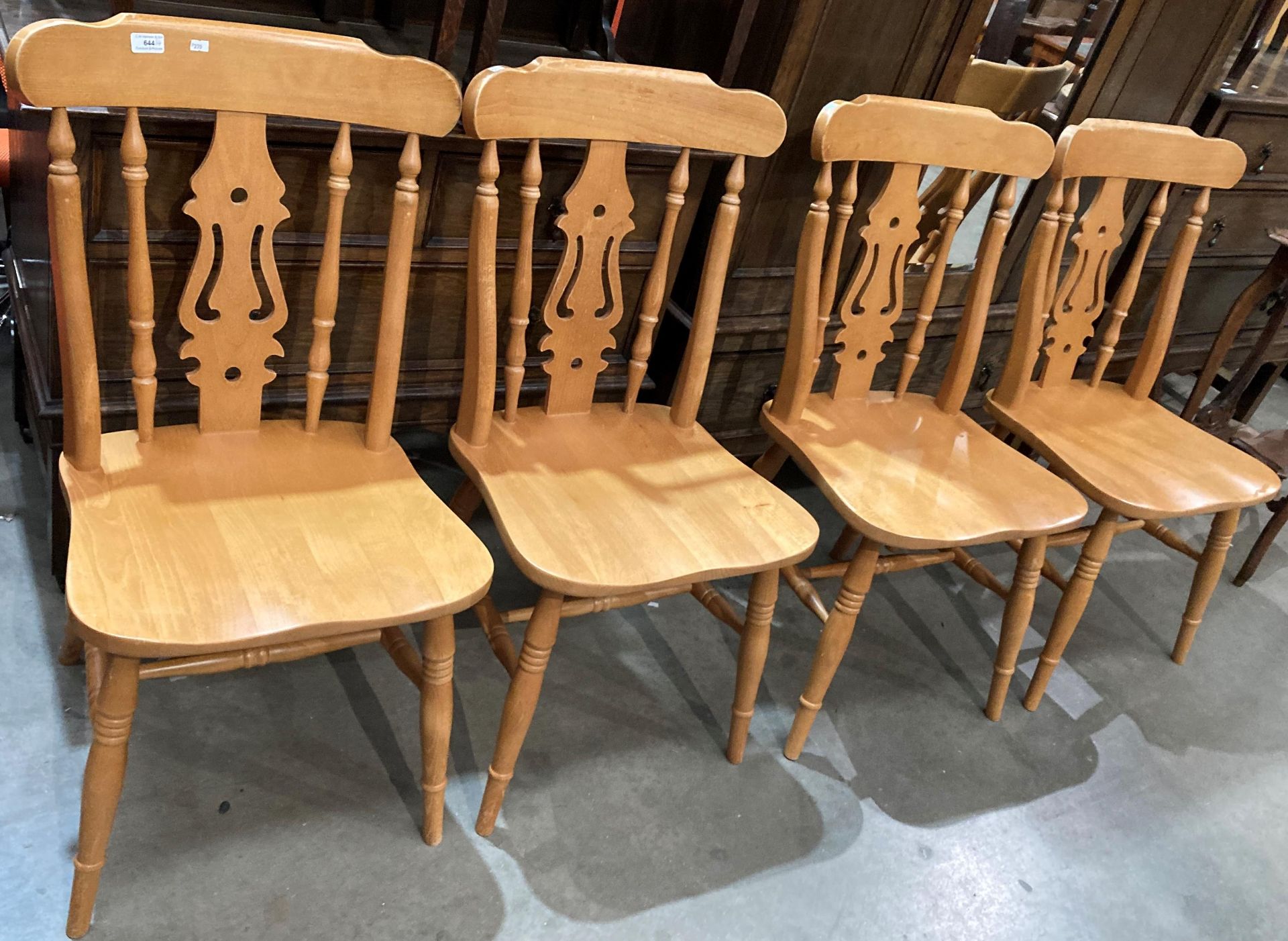 A set of four pine dining chairs with rail and centre splat backs.