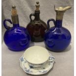 A blue glass decanter with metal top, handle chipped and repaired,