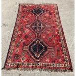 Red, brown and black triangular patterned rug 150cm x 246cm - needs a good clean.