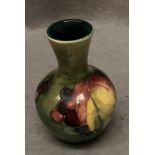 A Moorcroft small green ground vase,