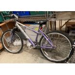 A Magna Envy 18.5" 18 speed bicycle in grey and purple.