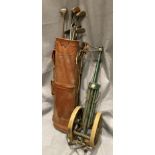 Vintage brown vinyl golf bag and blue metal trolley complete with golf clubs including a hickory