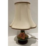 A Moorcroft green ground table lamp with shade,