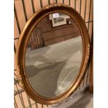 Ornate gilt framed oval mirror,