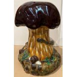 A brown glazed majolica style mushroom ornament with snake entwined around the base, 54cm high,