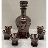 A small purple etched glass decanter, 22cm high, and six matching shot glasses.