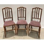 Three mahogany ladder back dining chairs with purple padded seats