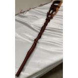 An African carved walking stick, 92cm long, with animal ornamentation.