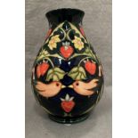 A Moorcroft blue ground fruit and bird patterned vase, 20cm high,