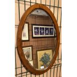 A mahogany oval framed wall mirror,