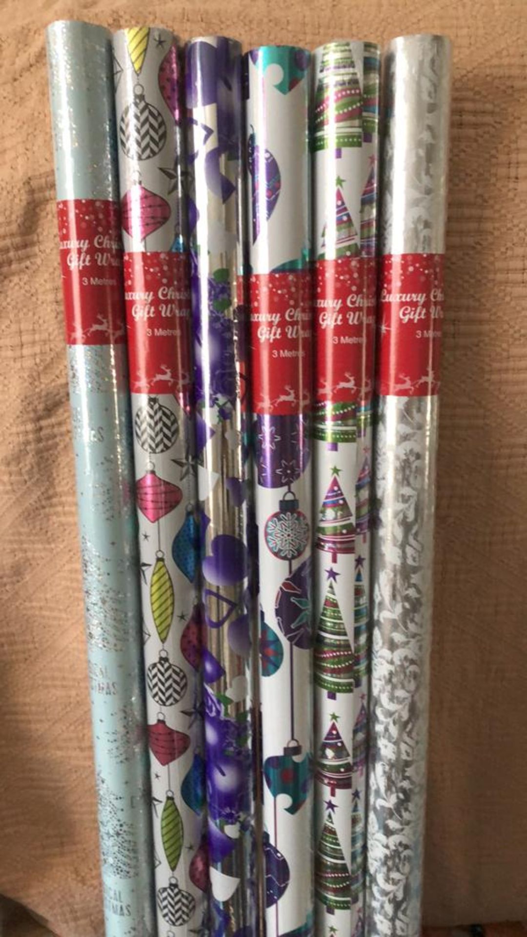 50 ROLLS ASSORTED XMAS WRAP VARIOUS DESIGNS AND SIZES