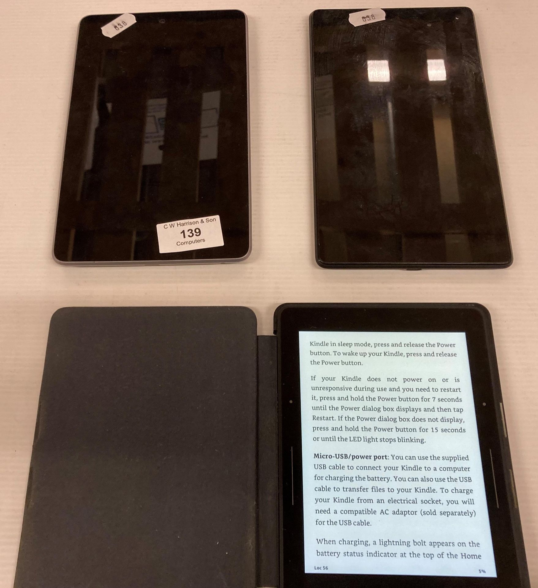 2 x Nexus hand held tablets and an Amazon Kindle in black case - no power leads (saleroom location