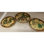 Three brown, yellow and green glazed wall plates - surrealist look to them,