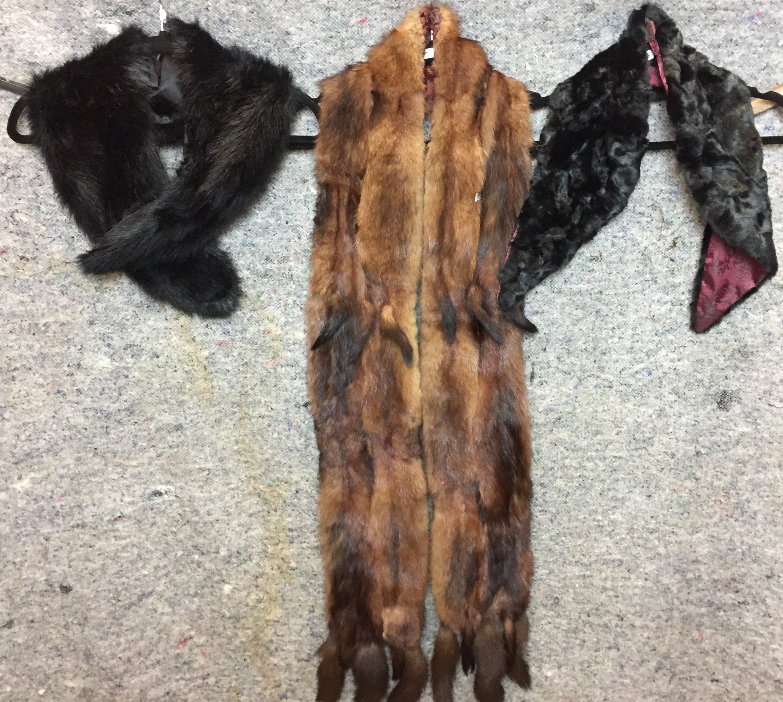 Three fur accessories - two black collars and a long mink stole (Saleroom location: on rail at