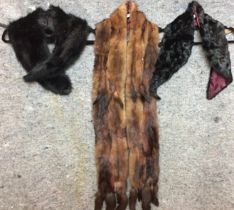 Three fur accessories - two black collars and a long mink stole (Saleroom location: on rail at