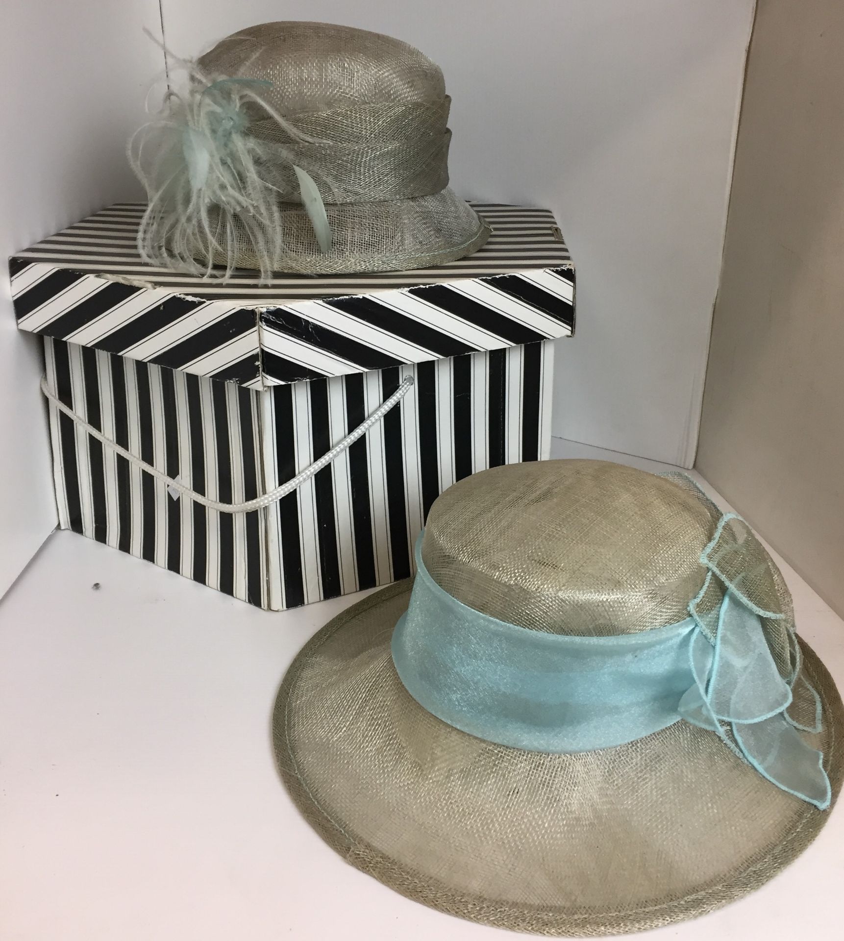 Two grey and turquoise ladies hats and black and white hat box (Saleroom location: N03)