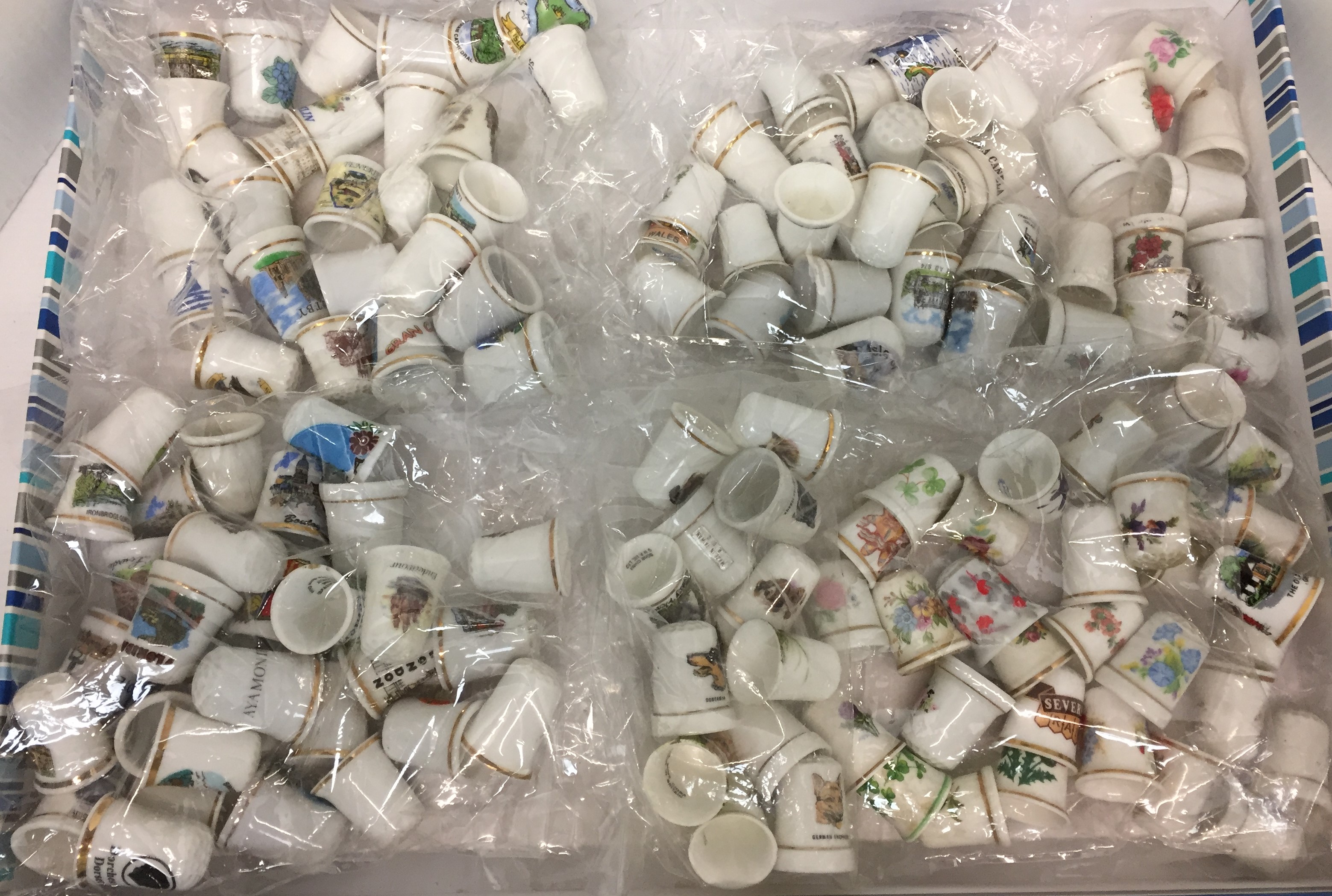 One hundred and thirty plus ceramic thimbles (Saleroom location: J01)