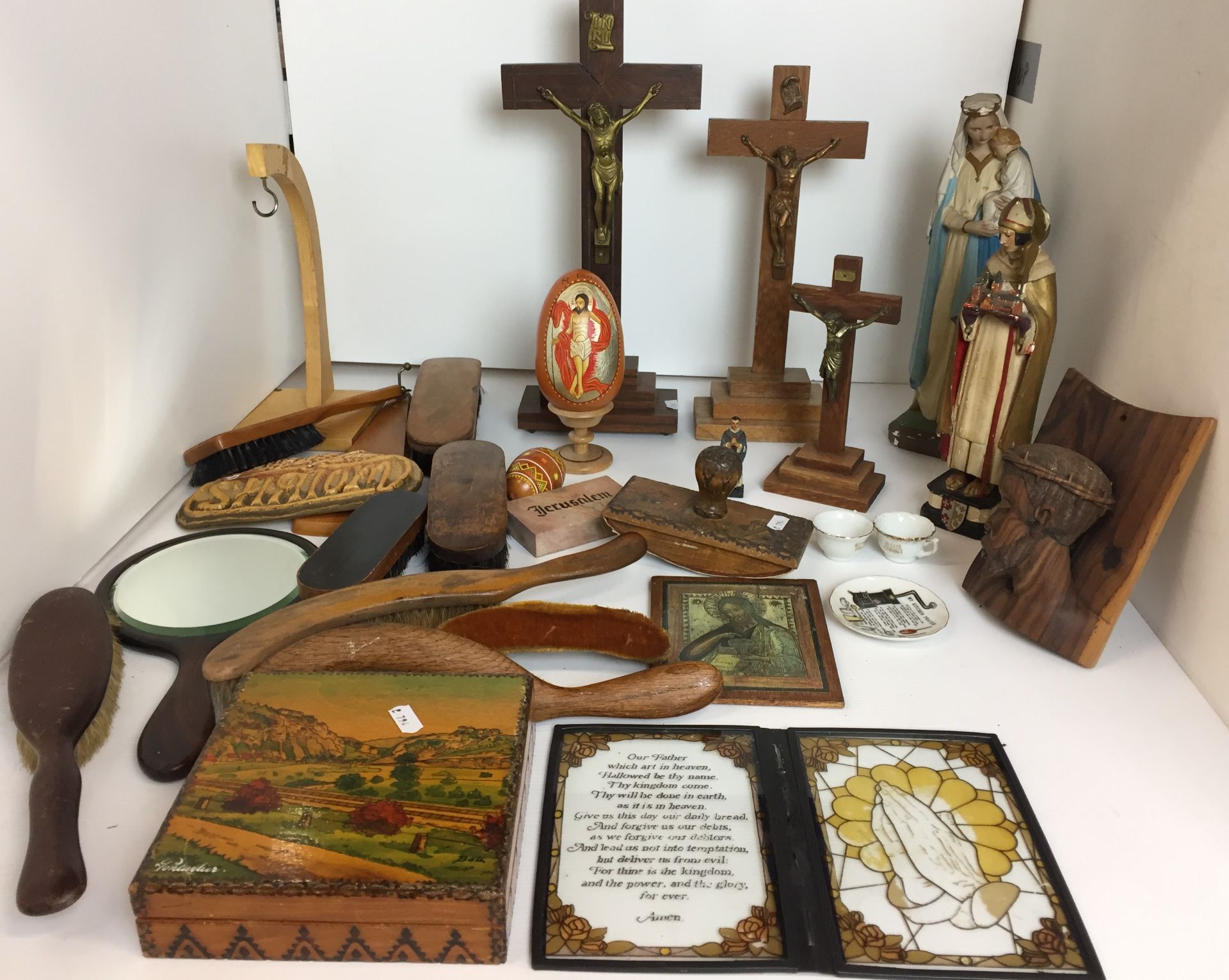 Twenty five plus items including three crucifixes, wooden carved wall hanging of Christ,