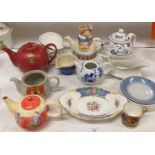 Contents to part of rack - ornamental and other tea pots,
