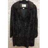 Ross Furriers black Persian Lamb three quarter length coat (hole to front) (Saleroom location: