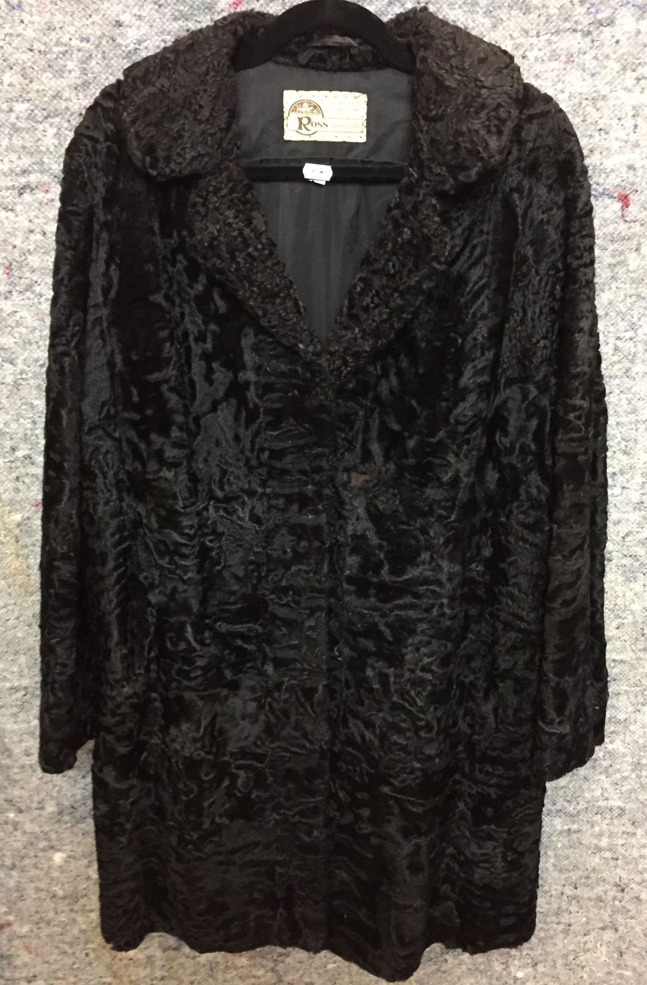Ross Furriers black Persian Lamb three quarter length coat (hole to front) (Saleroom location:
