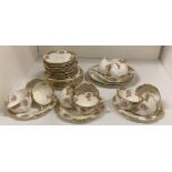 Contents to middle of rack - thirty-eight pieces of Court China rose and brown patterned tea