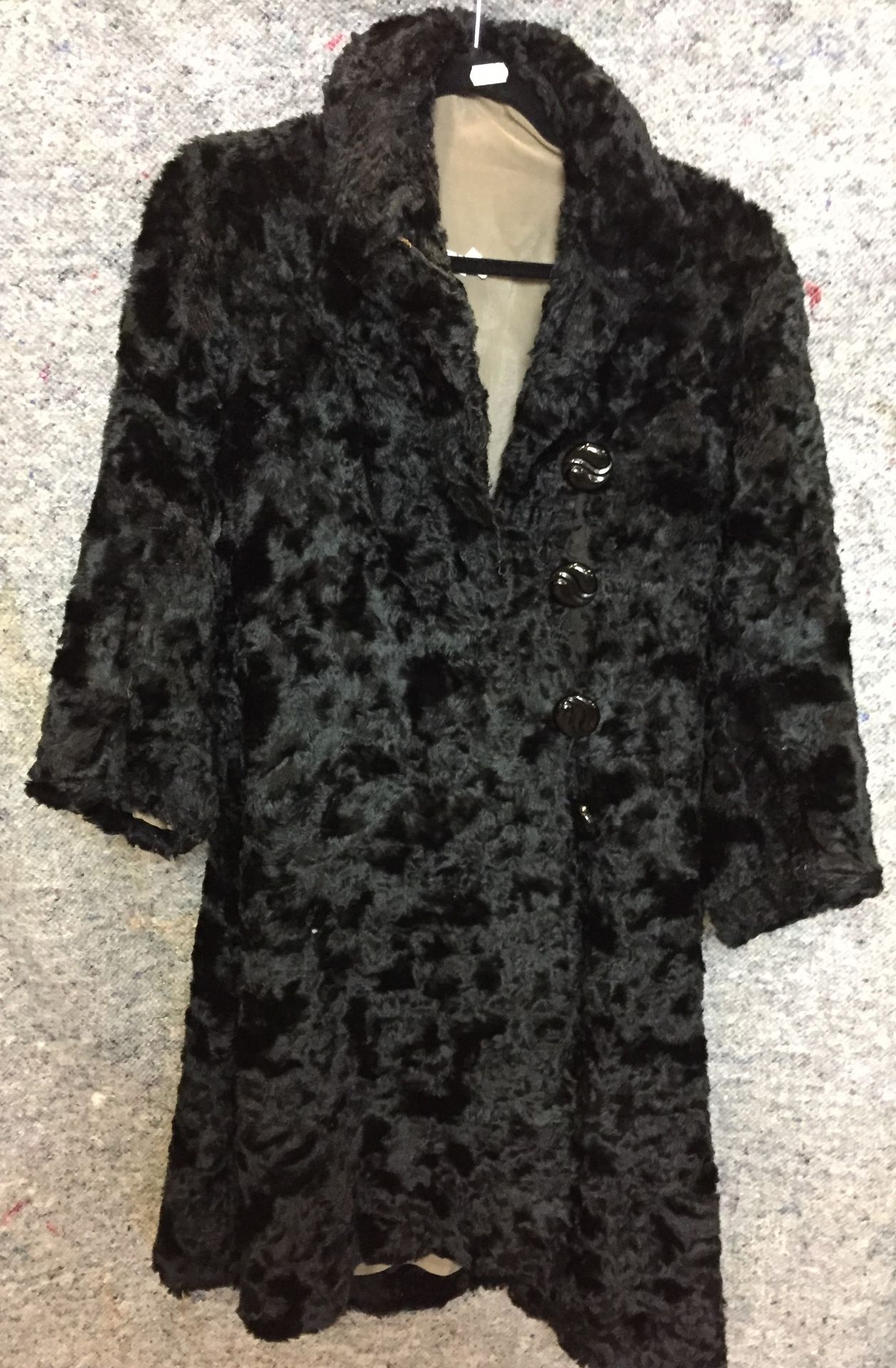 Black Persian Lamb coat with four black buttons (Saleroom location: on rail at S13)