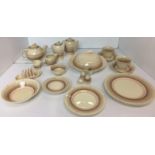 Twenty two pieces of Susie Cooper cream brown and pink breakfast service including covered
