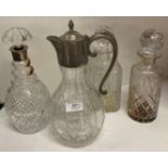 A glass claret jug with metal lid and handle,