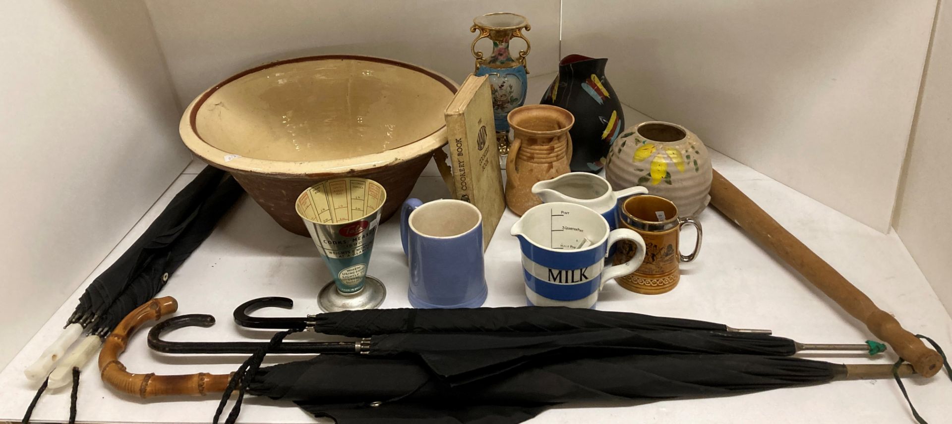 Remaining contents to rack - pancheon (with cracks), wood truncheon, parasols, Tala measuring jug,