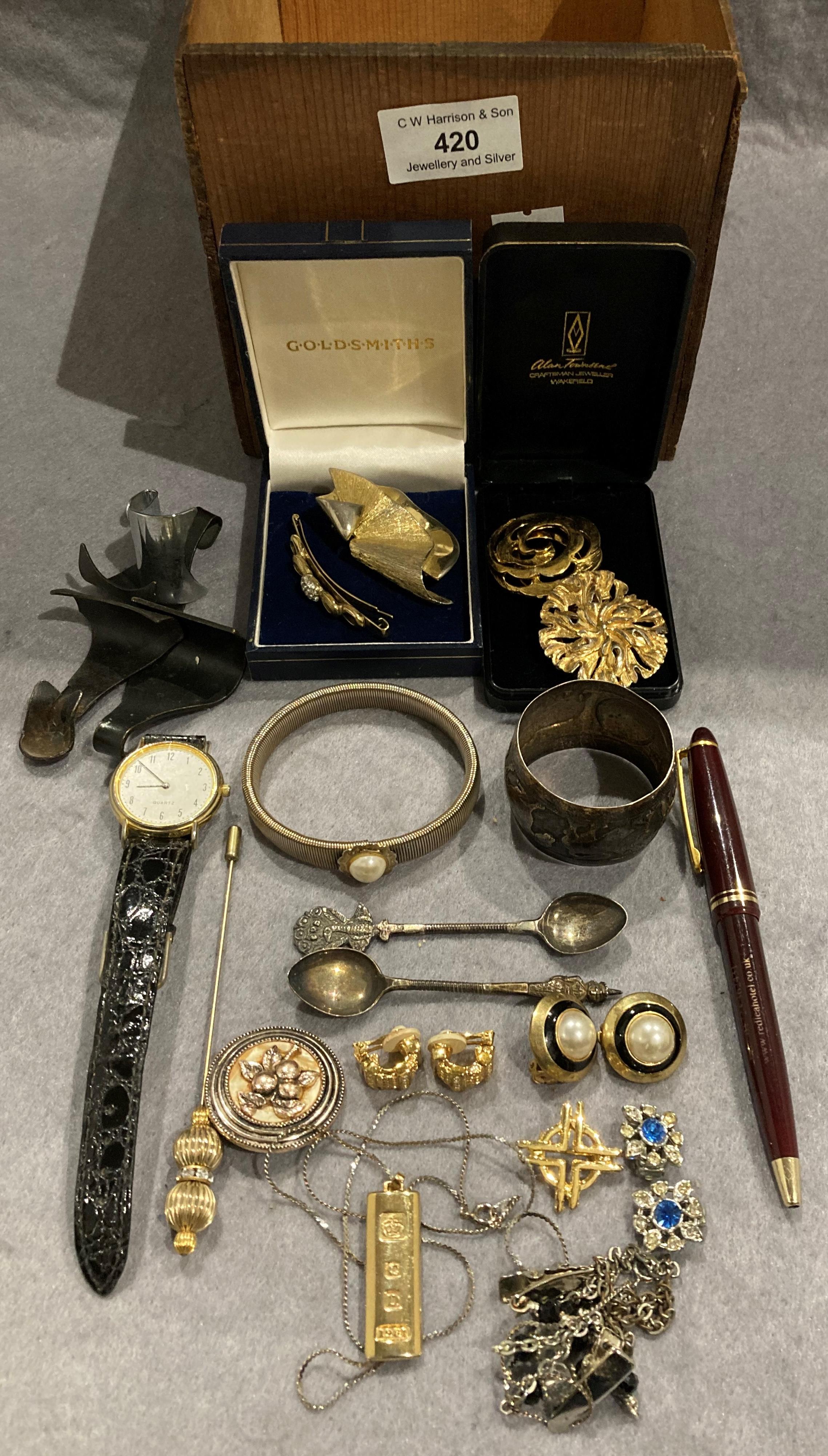 Contents to box - six brooches, gold coloured ingot with stamps, two silver teaspoons, earrings,