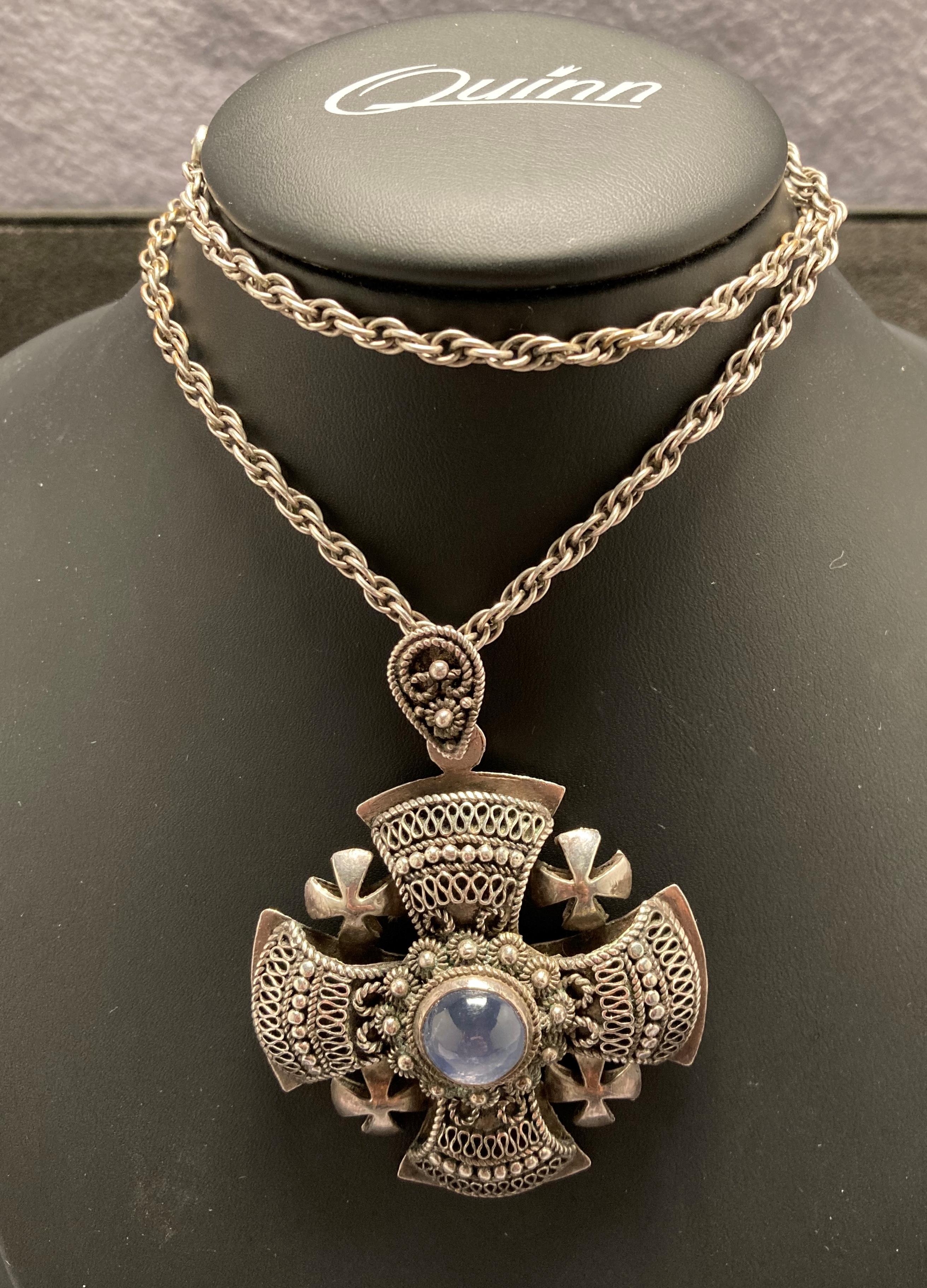 Silver Jerusalem pendant with central light blue stone (possibly moonstone) and a rope link chain