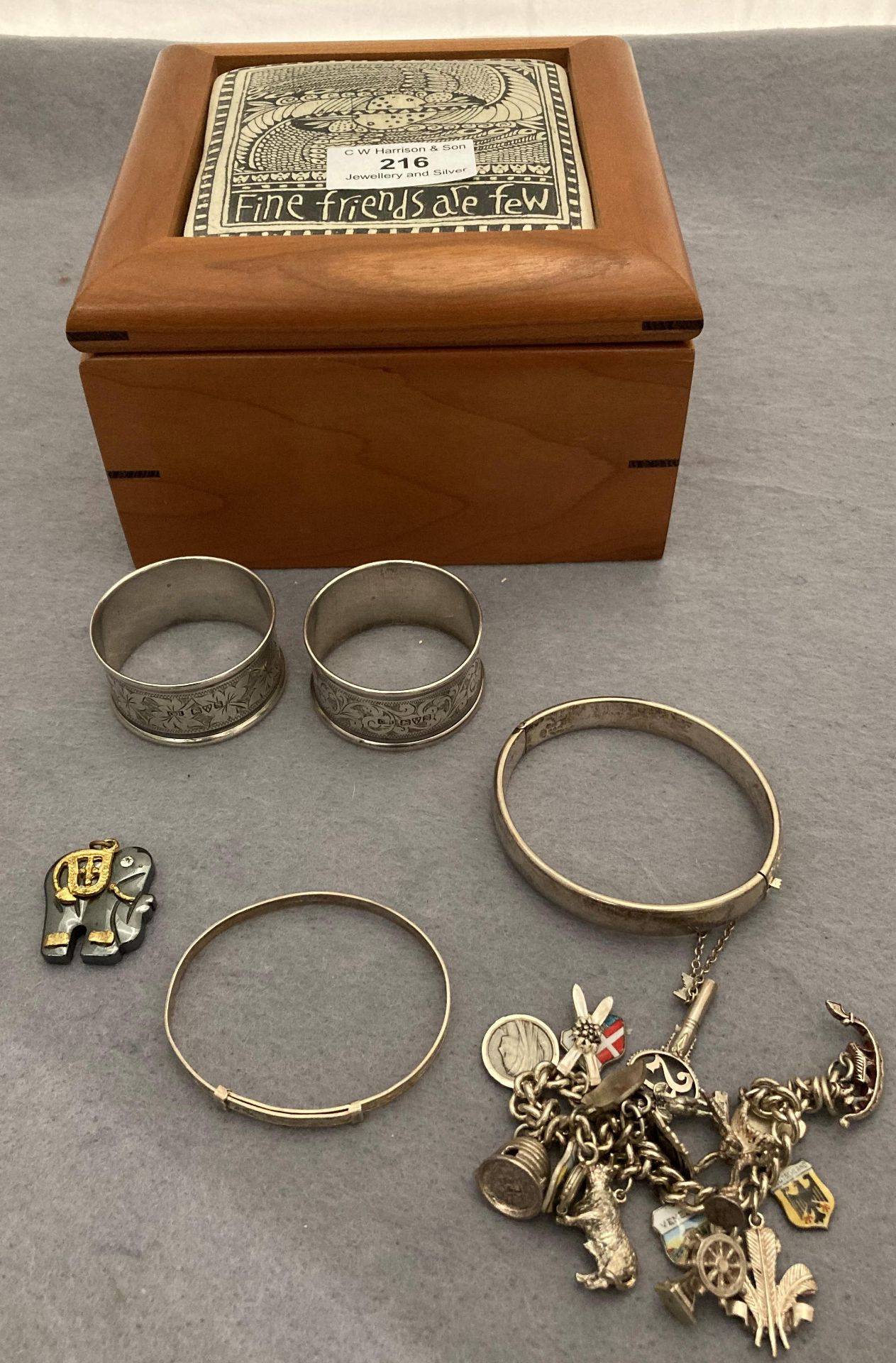 Contents to wooden box - silver charm bracelet,