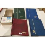 Four stamp albums and contents featuring stamps from Switzerland and a box of Swiss First Day