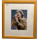 A signed colour photograph of Mick Jagger 26cm x 20cm in yellow frame (slight scratches to frame)